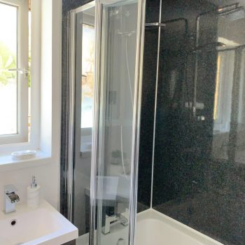 Fully fitted bathroom P shape bath, large head shower, heated towel rail and illuminated mirror